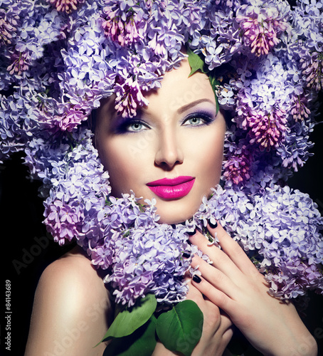 Beauty fashion model girl with lilac flowers hairstyle