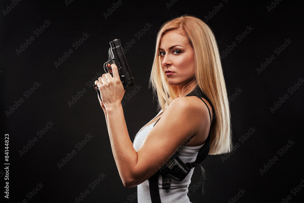 Beautiful woman with gun Stock Photo | Adobe Stock