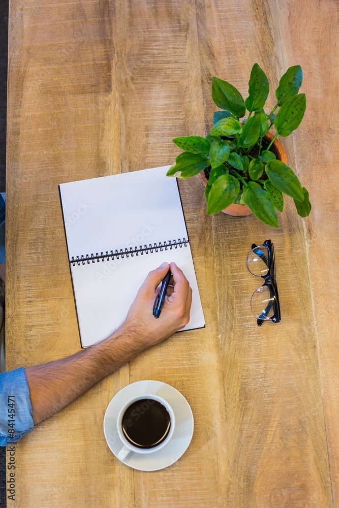 Man writing in notepad Man writing in notepad