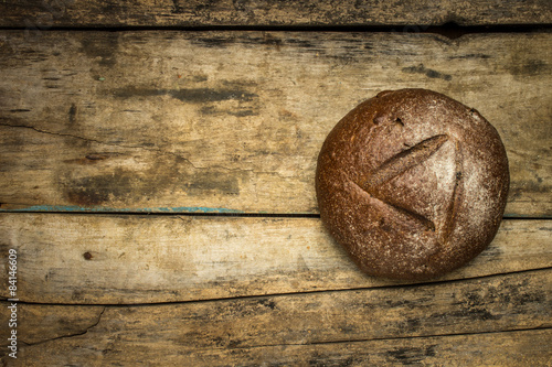 Bakery background with loaf of bread on wooden table