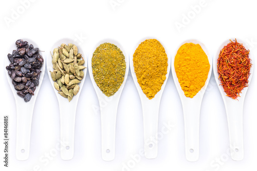 Diverse of spices in ceramic spoon isolated on white background