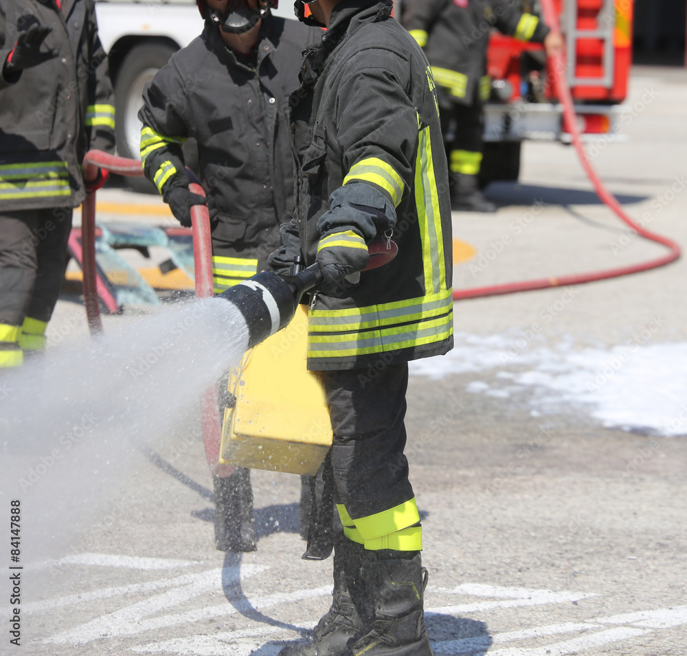 firefighters with the fire extinguisher during a practice sessio firefighters with the fire extinguisher during a practice sessio