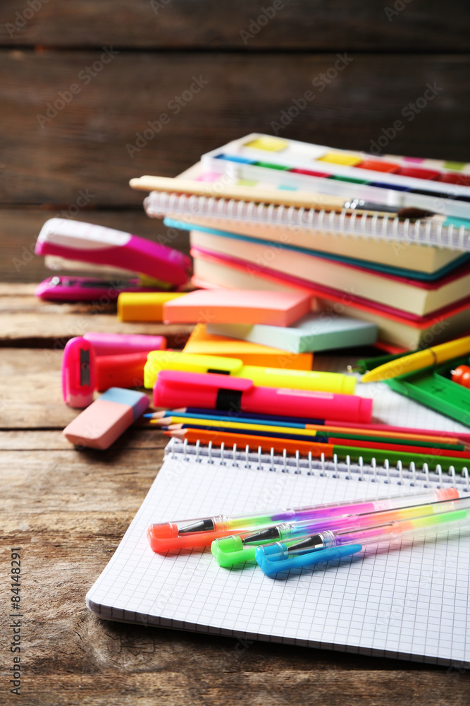 Bright school stationery on old wooden table Bright school stationery on old wooden table