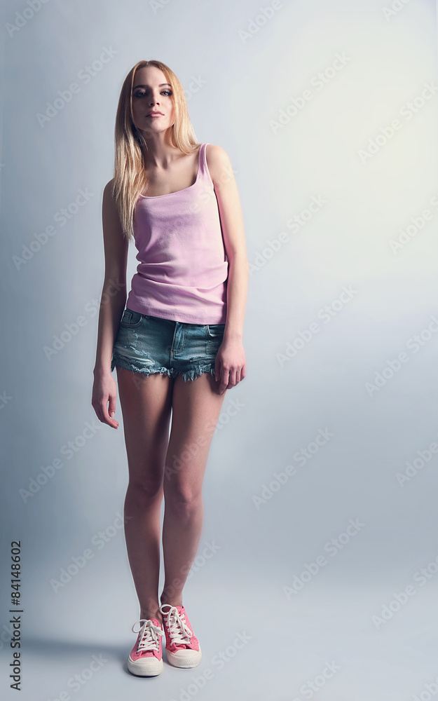 Expressive young model in casual style on gray background Expressive young model in casual style on gray background