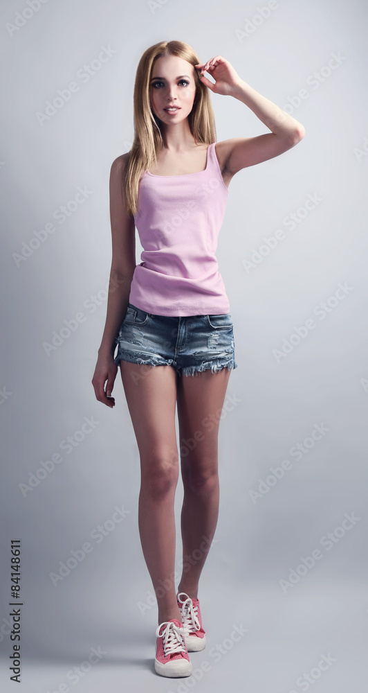 Expressive young model in casual style on gray background Expressive young model in casual style on gray background