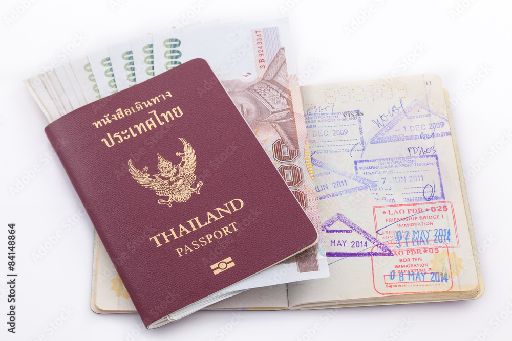Thailand passport and Thai money for travel isolated on white ba Thailand passport and Thai money for travel isolated on white ba