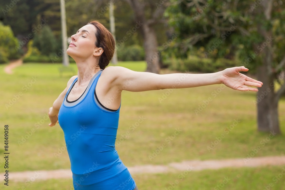Pretty brunette stretching her arms during jogging Pretty brunette stretching her arms during jogging