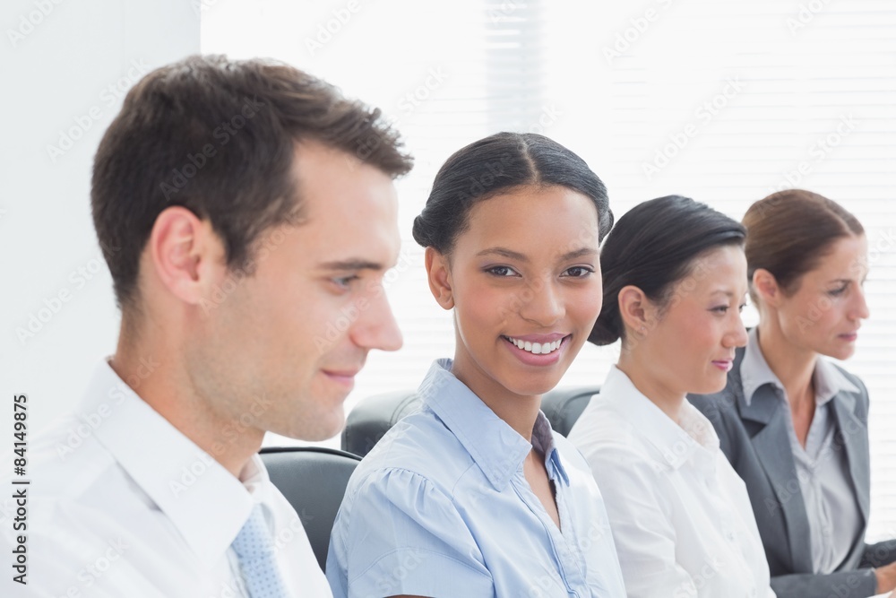 Smiling business people looking at camera Smiling business people looking at camera