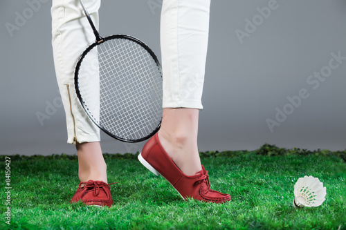 Woman's Legs And Badminton Racket