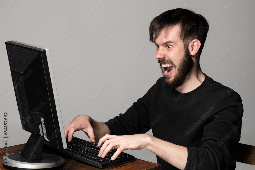 Funny and crazy man using a computer Funny and crazy man using a computer