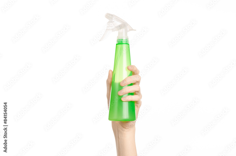 man's hand holding a green spray bottle for cleaning man's hand holding a green spray bottle for cleaning