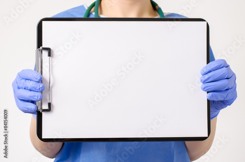 Doctor showing blank clipboard