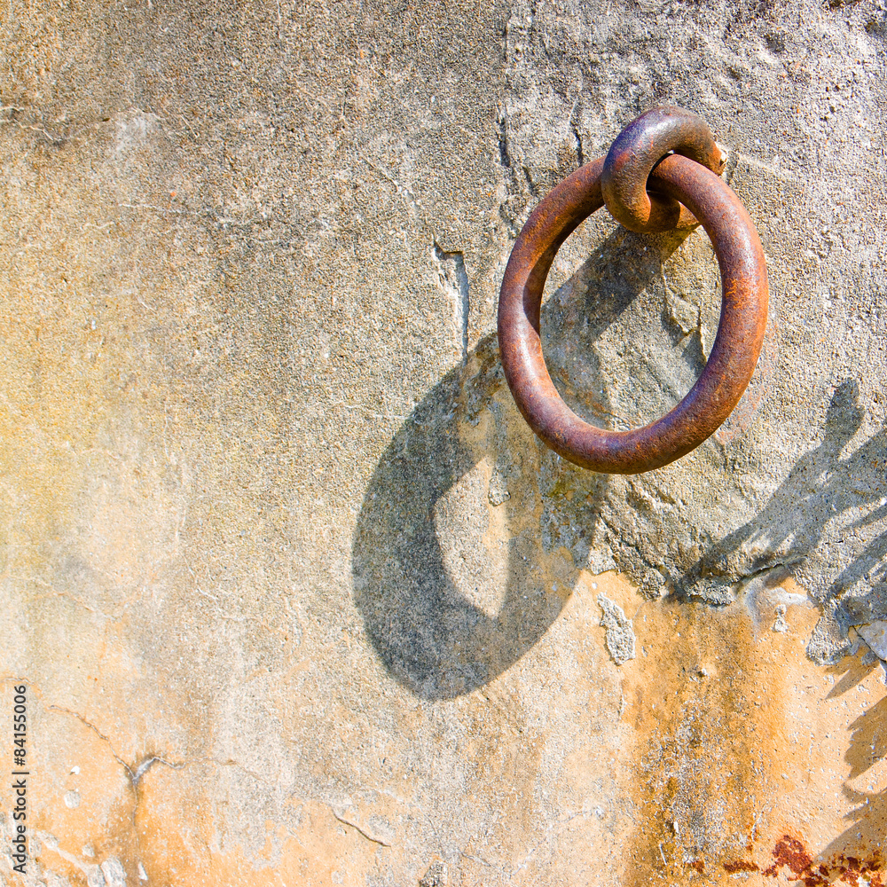 Old iron ring fixed in a plaster wall - toned image Old iron ring fixed in a plaster wall - toned image