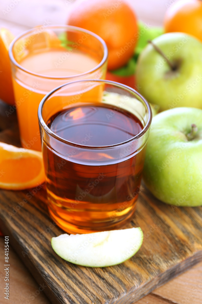 Assortment of healthy fresh juices and fruits on wooden table background Assortment of healthy fresh juices and fruits on wooden table background