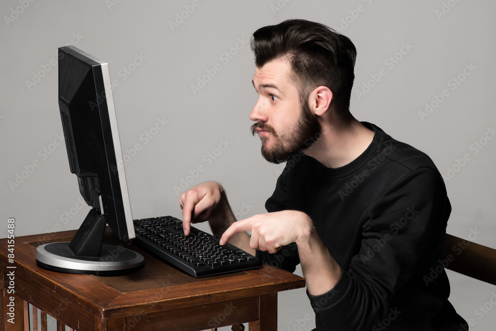 Funny and crazy man using a computer Funny and crazy man using a computer