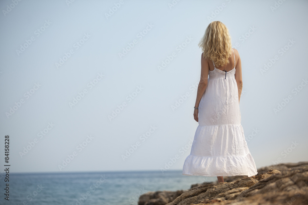 woman meditating and relaxing on beach