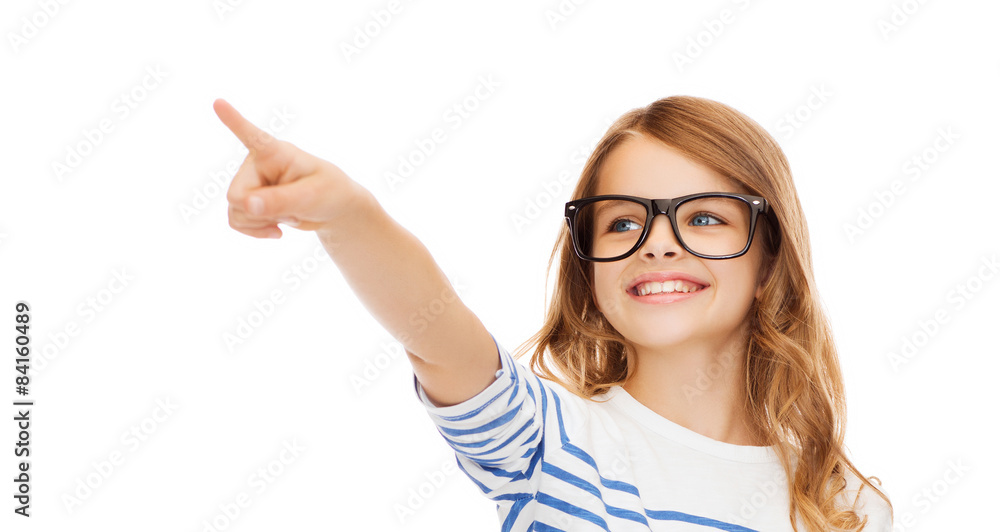 cute little girl in eyeglasses pointing in the air cute little girl in eyeglasses pointing in the air
