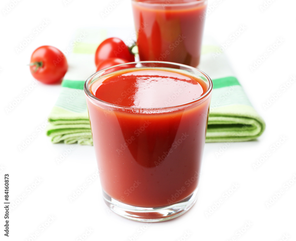 Glasses of fresh tomato juice on checkered napkin, isolated on white Glasses of fresh tomato juice on checkered napkin, isolated on white