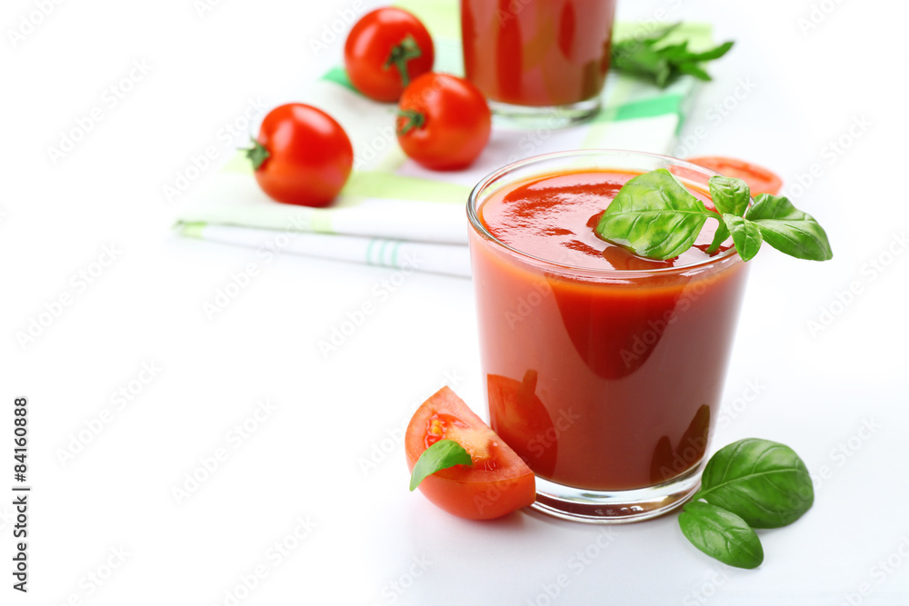 Glasses of fresh tomato juice on checkered napkin, isolated on white Glasses of fresh tomato juice on checkered napkin, isolated on white
