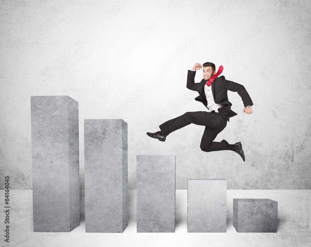 Successful business man jumping over charts on background Successful business man jumping over charts on background