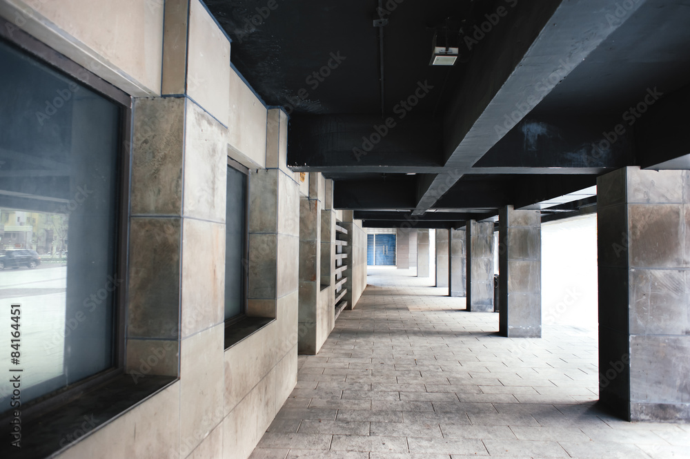 clean hallway with columns and dark ceiling
clean hallway with columns and dark ceiling