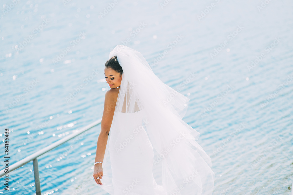 Bride posing on the pier at the lake