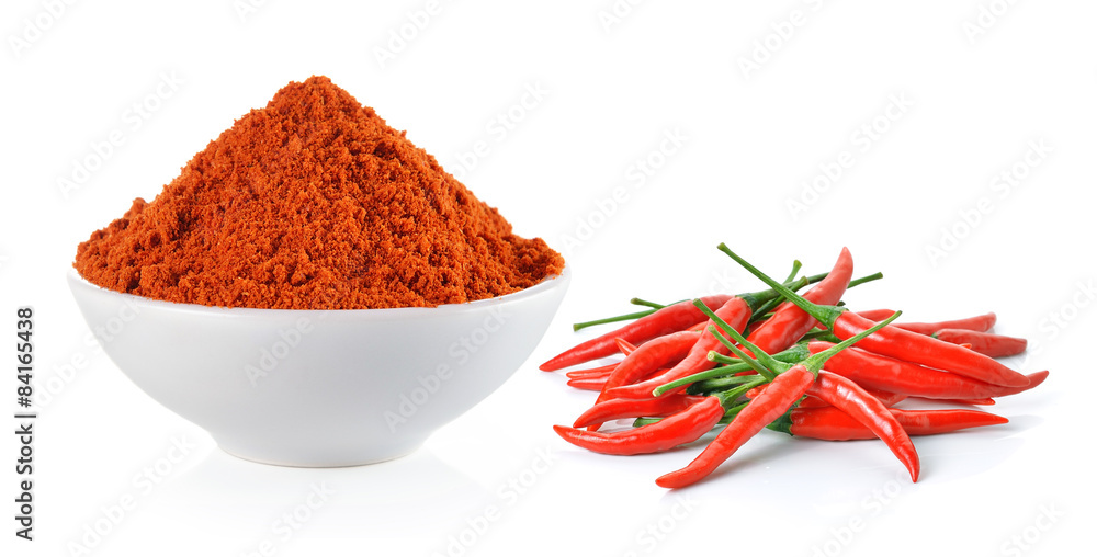 Powdered dried red pepper and red chili peppers in a white bowl Powdered dried red pepper and red chili peppers in a white bowl