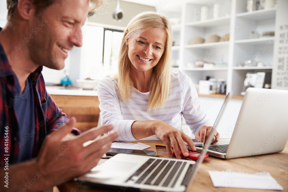 Man and woman working together at home Man and woman working together at home