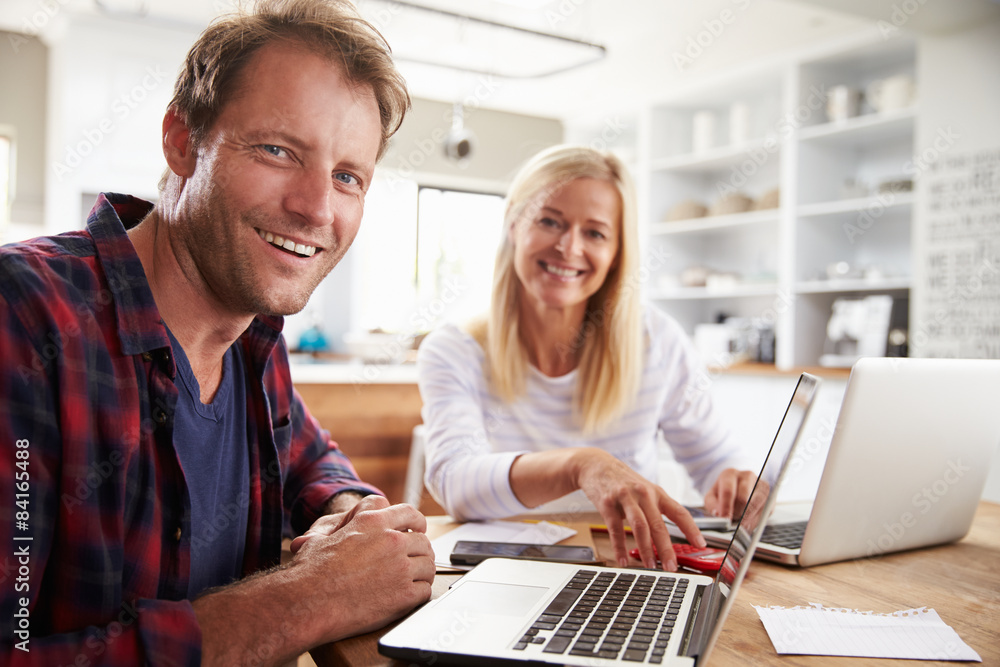 Man and woman working together at home Man and woman working together at home