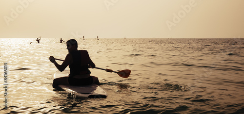 Young Man Paddleboarding photo