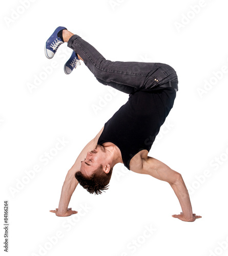 Break dancer doing handstand against white background