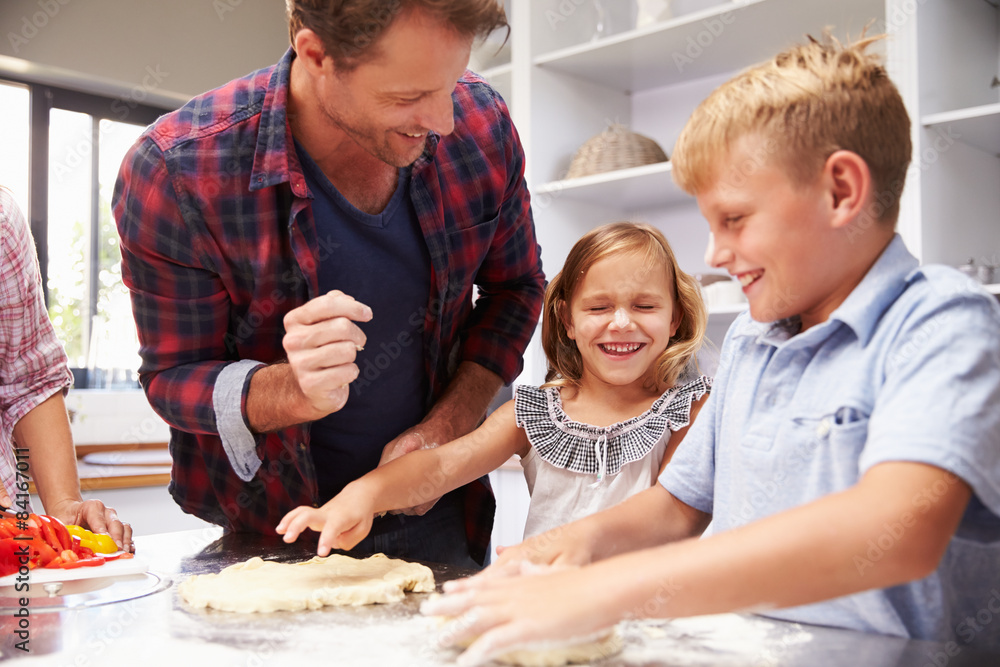 Father making pizza with kids Father making pizza with kids