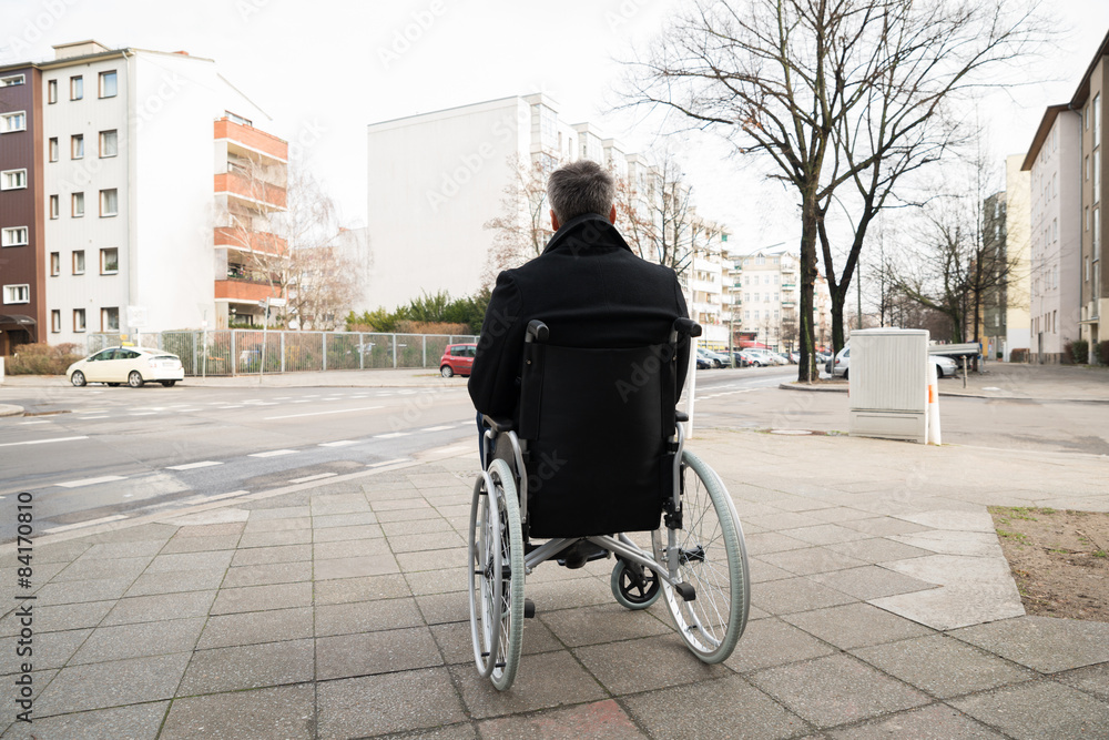Disabled Man On Wheelchair Looking At Street