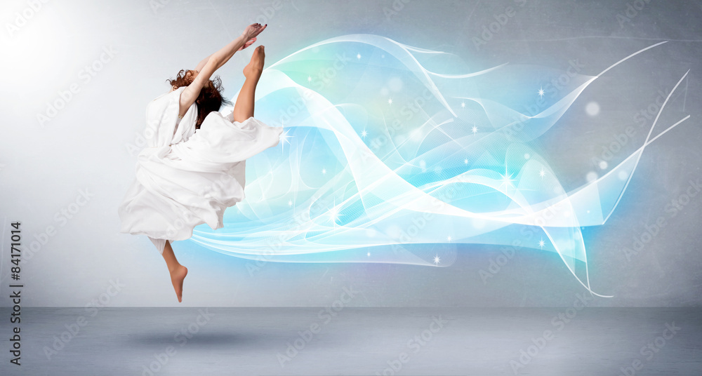 Cute teenager jumping with abstract blue scarf around her Cute teenager jumping with abstract blue scarf around her