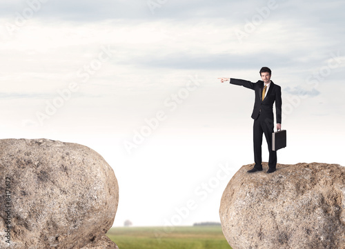 Businessman on rock mountain