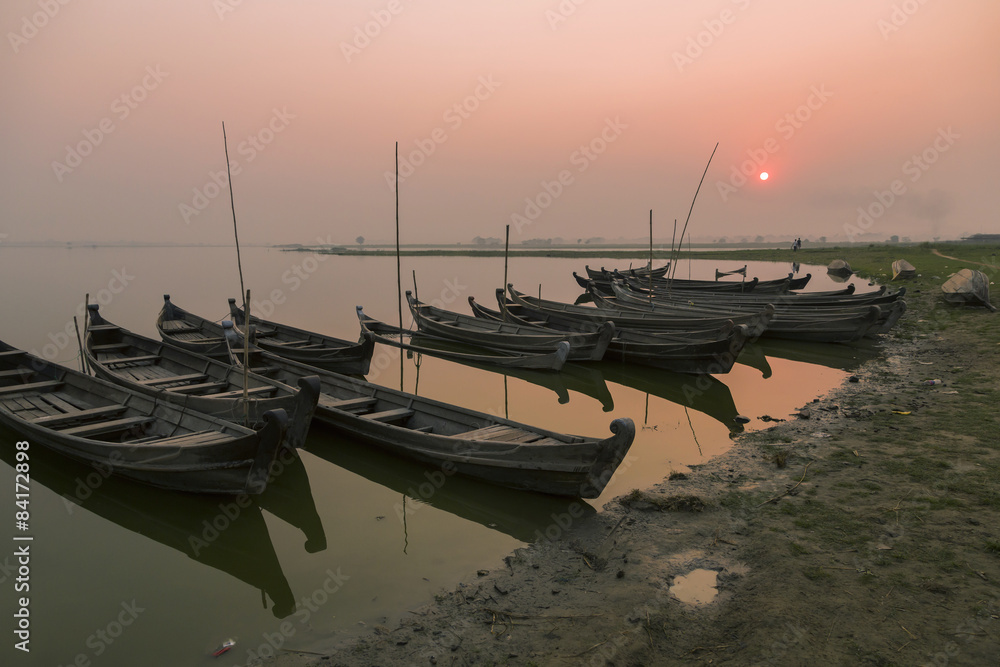 Fototapeta premium Wooden boats of fishermen at sunset, Amarapura, Myanmar