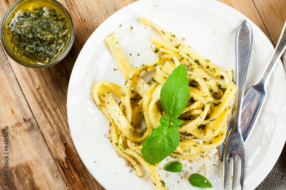Cooked homemade pasta with pesto and basil Cooked homemade pasta with pesto and basil