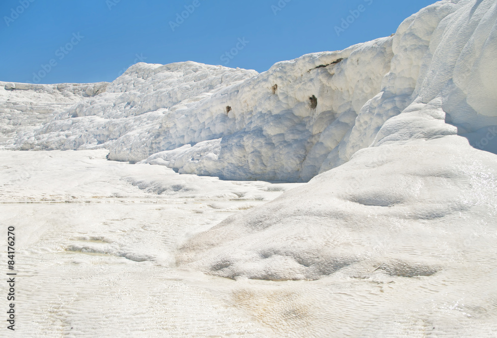 white travertine and flowing water against blue sky