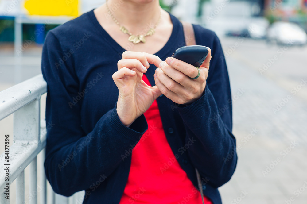 Woman using smart phone in the street Woman using smart phone in the street