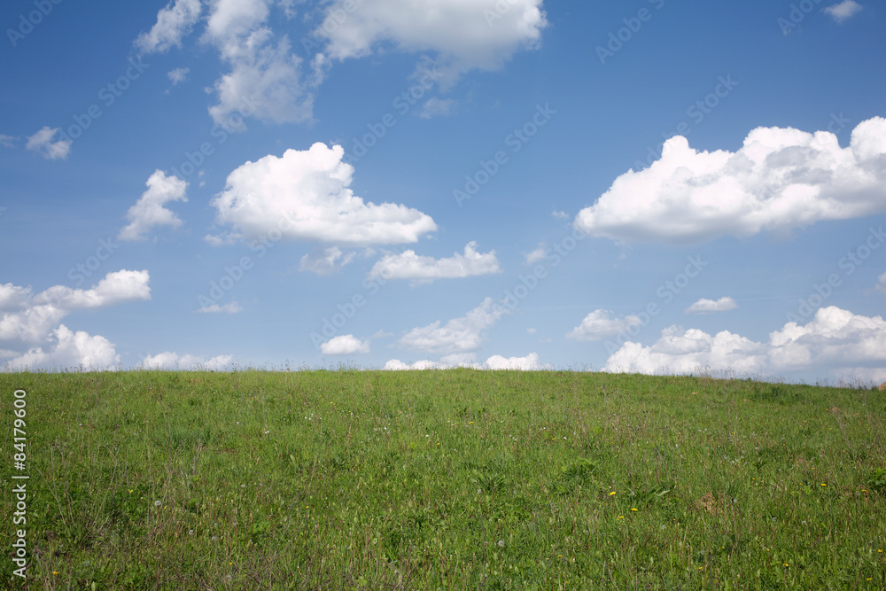 Rustic landscape with meadow and beautiful sky with clouds