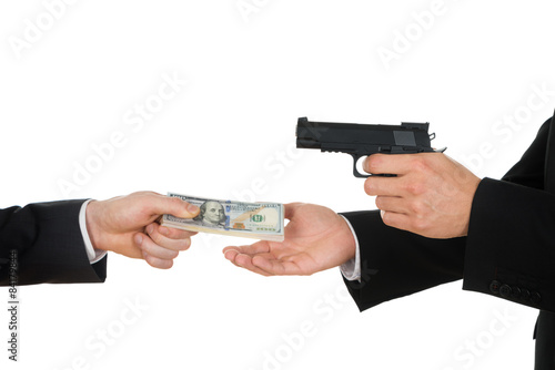 Businessman Giving Money To The Businessperson With Gun