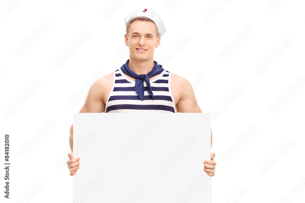 Young handsome sailor holding a blank banner and looking at the Young handsome sailor holding a blank banner and looking at the