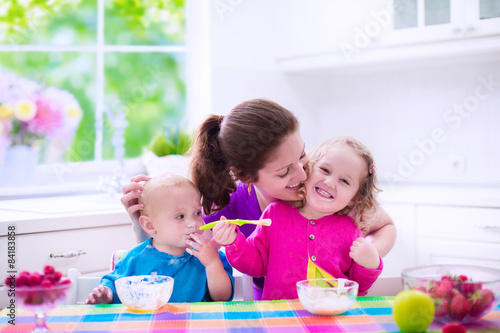 Mother and children having breakfast