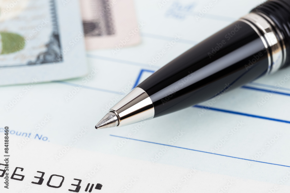 Check with pen and banknote Check with pen and banknote