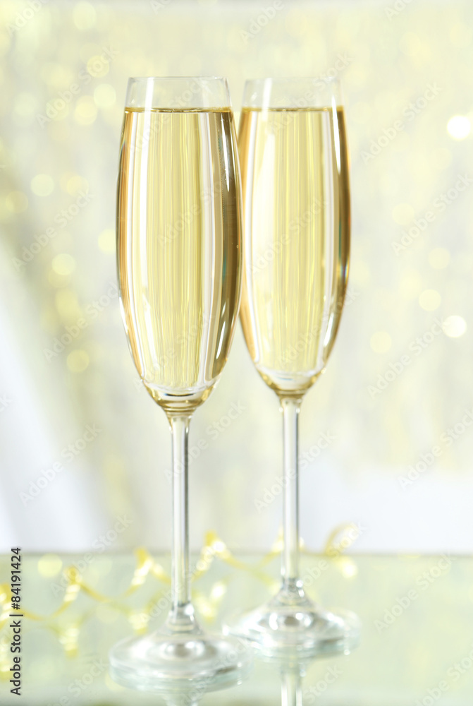 Glasses of champagne on lights background Glasses of champagne on lights background