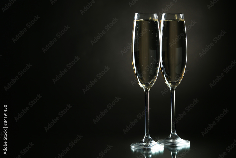 Glasses of champagne on a black background