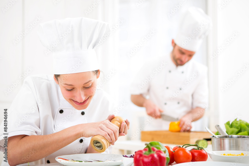 Young attractive professional chef cooking in his kitchen Young attractive professional chef cooking in his kitchen