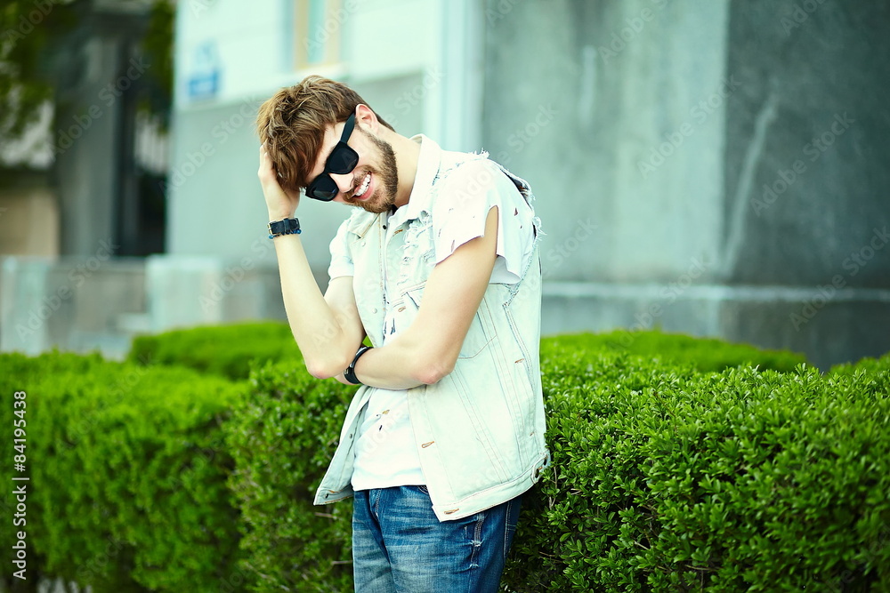 Funny smiling hipster man in casual cloth in the street Funny smiling hipster man in casual cloth in the street