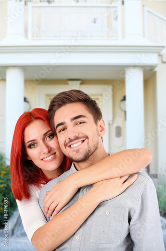 Loving couple near their house