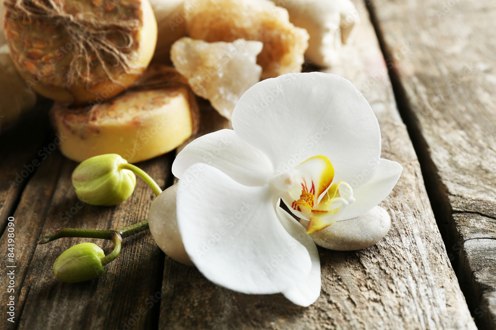 Still life with beautiful blooming orchid flower, spa treatment on wooden background Still life with beautiful blooming orchid flower, spa treatment on wooden background